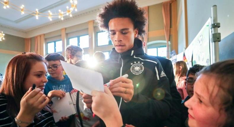 Manchester City winger Leroy Sane (C) signs autographs after Germany's stars held a press conference at a school in Leipzig on Tuesday in which school children were also allowed to ask questions ahead of the friendly against Russia on Thursday.