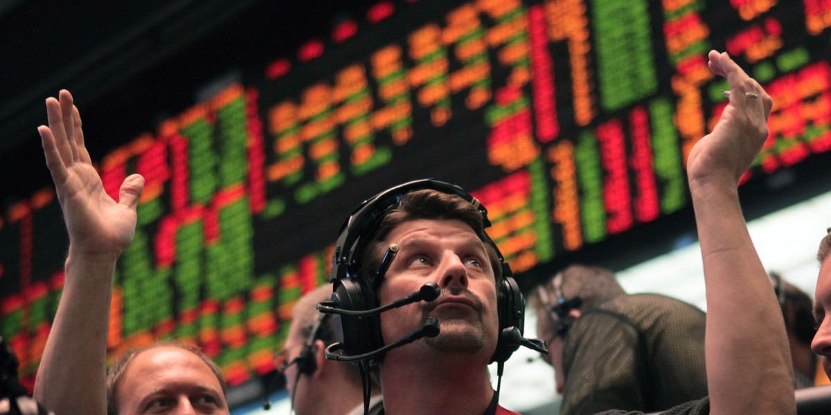 A trader signals an offer in the Eurodollar pit at the CME Group prior to the Federal Reserve's announcement that interest rates would remain unchanged November 2, 2011 in Chicago, Illinois.