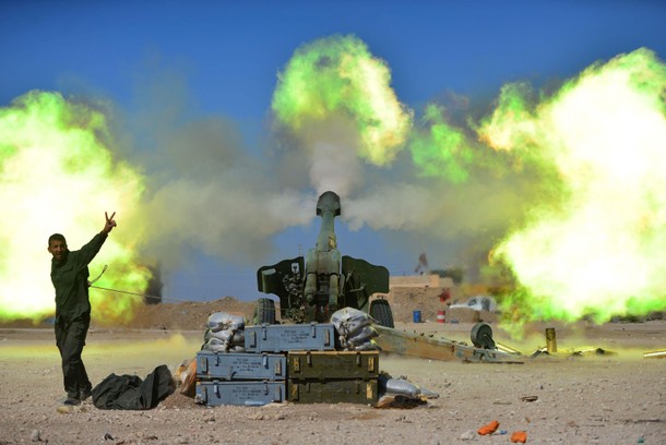 Popular Mobilization Forces (PMF) fires towards Islamic State militants during a battle with Islamic