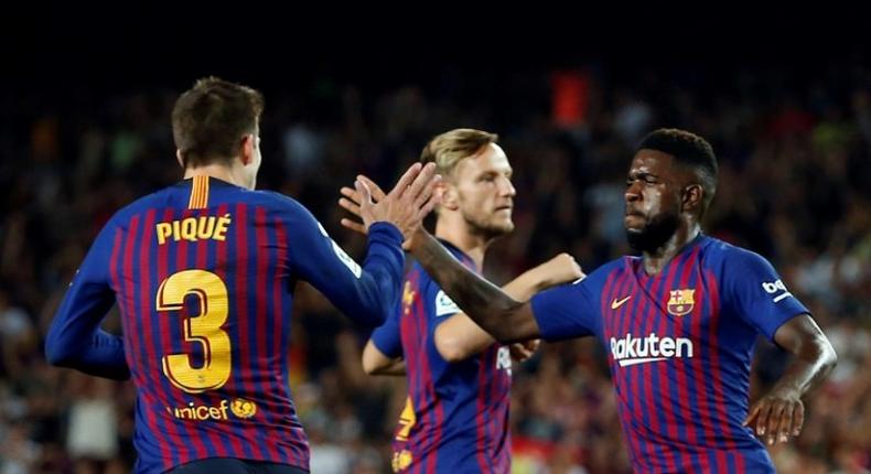 Barcelona defender Samuel Umtiti (R) congratulates Spanish team-mate Gerard Pique for his equaliser in a 202 draw with Gerona.