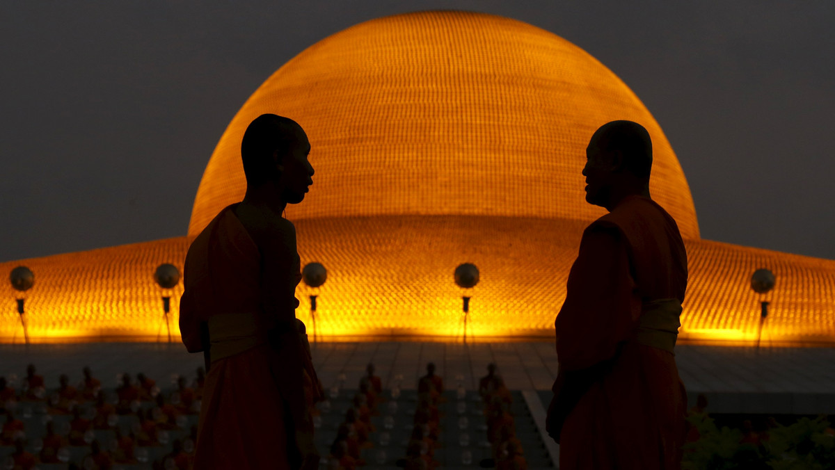 A Buddhist monk stands in front of the Wat Phra Dhammakaya temple in Pathum Thani province, north of Bangkok before a ceremony on Makha Bucha Day