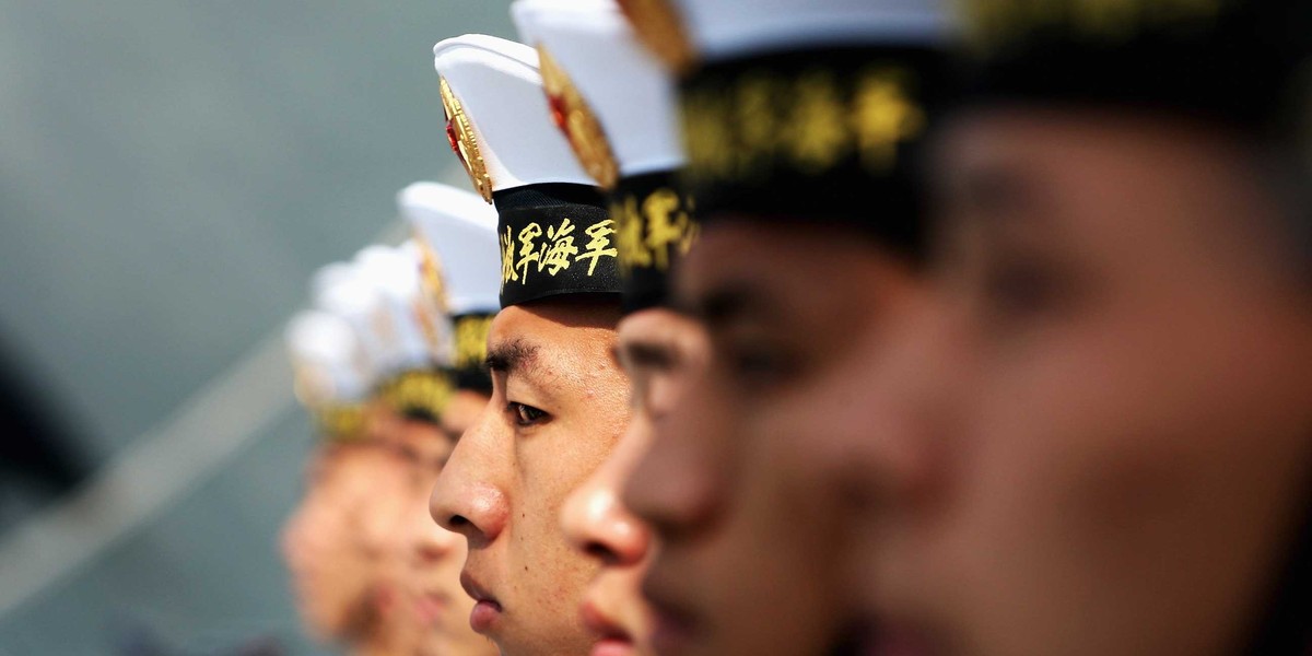 Chinese navy soldiers guard on Navy Battleship of Wenzhou at Qingdao Port on April 22, 2009 in Qingdao of Shandong Province, China.