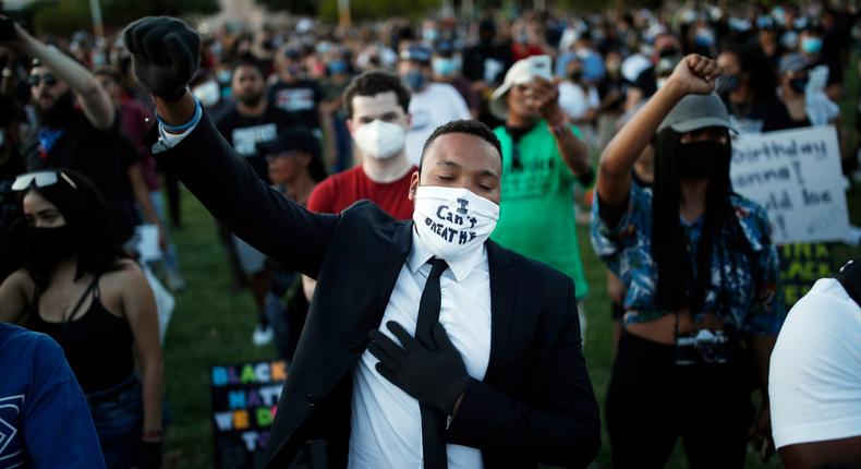 FILE - In this June 5, 2020 file photo, people raise their fists during a rally, in Las Vegas, against police brutality sparked by the death of George Floyd, a Black man who died after being restrained by Minneapolis police officers on May 25. A flood of donations during the surge of global protests following the death of Floyd have left racial equality and social justice groups in a position they might never have expected to be in: figuring out what to do with a surplus of cash.   (AP Photo/John Locher, File)