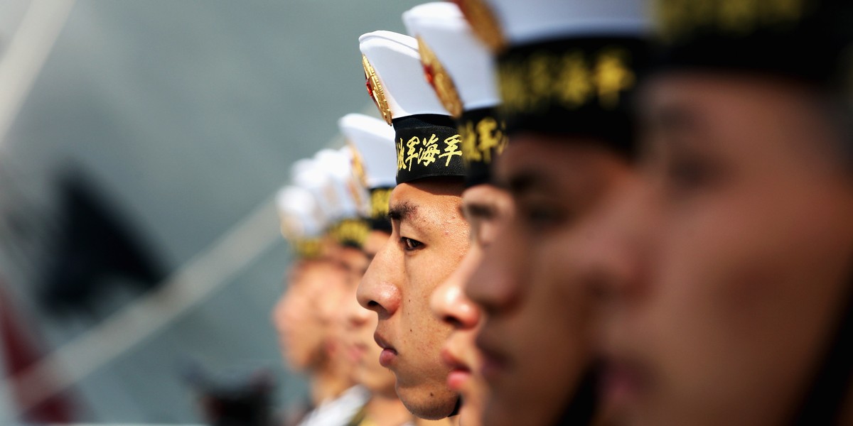 Chinese navy soldiers guard on Navy Battleship of Wenzhou at Qingdao Port on April 22, 2009 in Qingdao of Shandong Province, China.