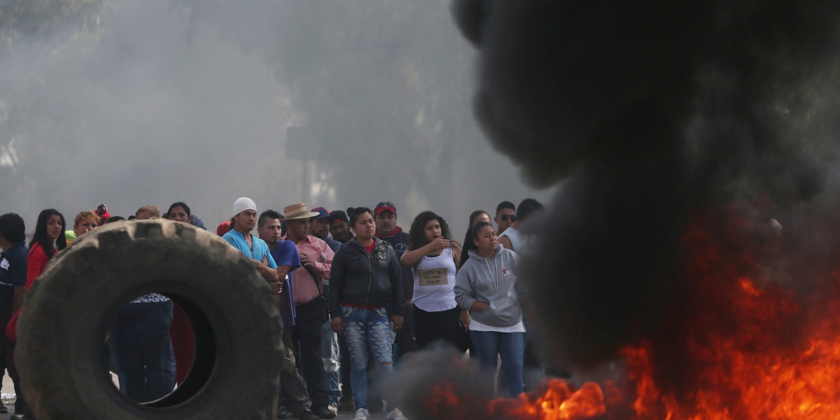 Protesters block the entrance to a Pemex gas station as they burn tires during a protest against the rising prices of gasoline enforced by the Mexican government, in San Miguel Totolcingo, Mexico, January 3, 2017.