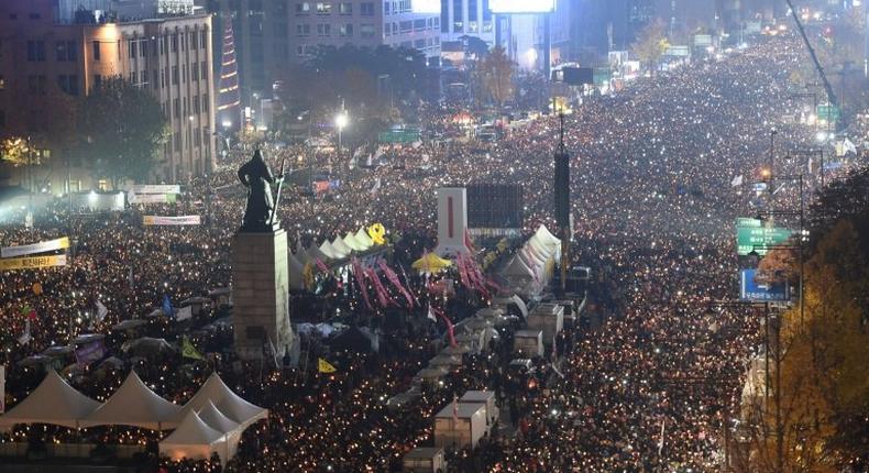 Tens of thousands of protesters hold candles during an anti-government rally in central Seoul on November 19, 2016 aimed at forcing South Korean President Park Geun-Hye to resign