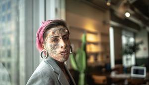 A woman in a business suit with face tattoos (stock photo).FG Trade/Getty Images