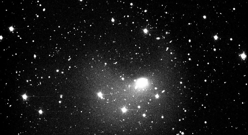 The solid body of 12P/Pons-Brooks is hidden underneath all the dust and gas in the central blob in the center of the image, taken at the 4.3-meter Lowell Discovery Telescope. T expanding ejecta from the late-July outburst can be seen as a faint two-tailed or two-horned structure at larger distances from the blob.Dr. Teddy Kareta/Lowell Observatory