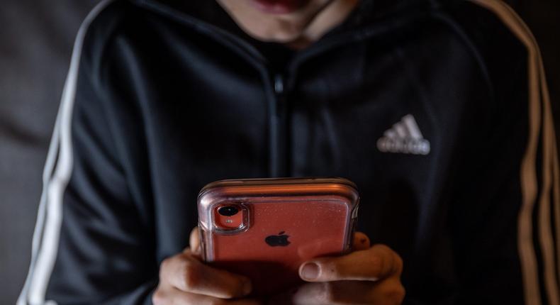 The voluntary smartphone ban seeks to limit anxiety and exposure to unsuitable materials for youth.Matt Cardy/Getty Images