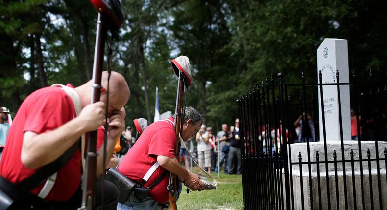 In this Aug. 27, 2017 file photo, members of the Sons of Confederate Veterans kneel in front of a new monument called the Unknown Alabama Confederate Soldiers in the Confederate Veterans Memorial Park in Brantley, Ala. As Confederate statues across the nation get removed, covered up or vandalized, some brand new ones are being built as well.