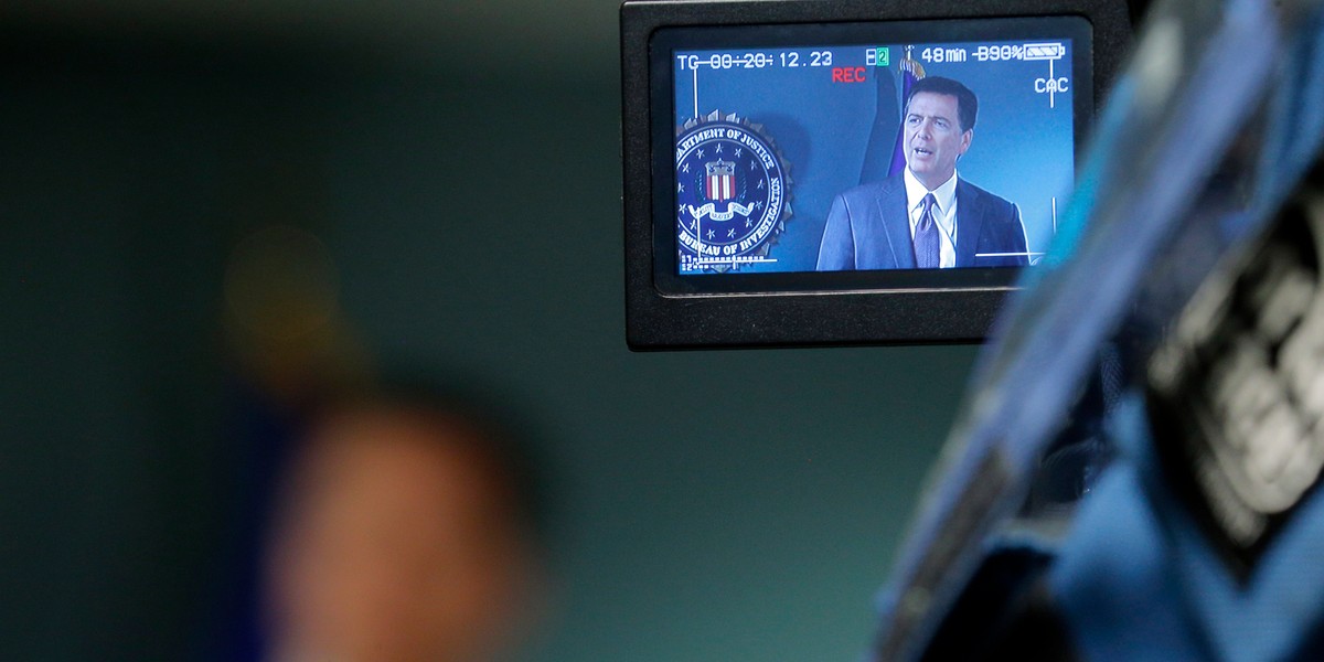 Cameras record FBI Director James Comey during a news conference at the FBI office.