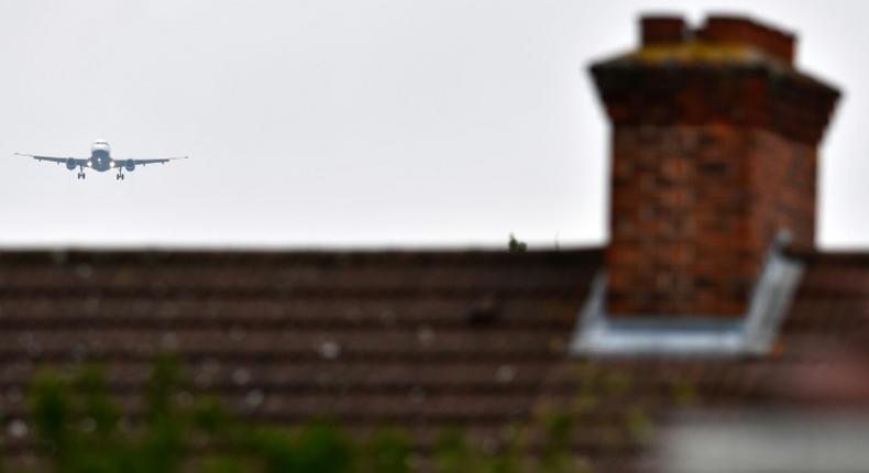 File picture shows a plane flying over residential houses as it prepares to land at London Heathrow Airport