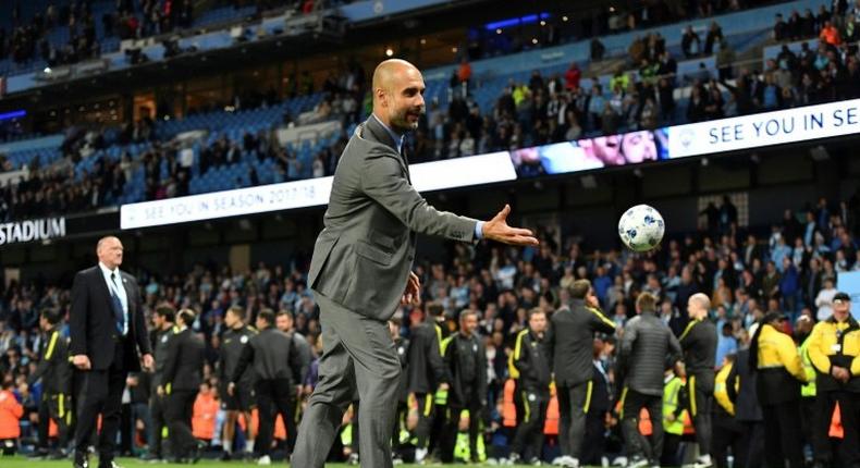 Manchester City's manager Pep Guardiola plays with a small ball on the pitch at the end of the English Premier League football match against West Bromwich Albion May 16, 2017