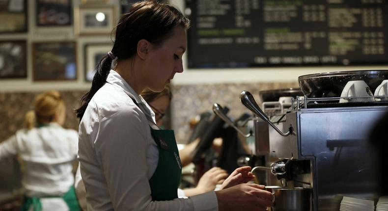 A barista prepares a drink at Starbucks' Vigo Street branch in Mayfair, central London.