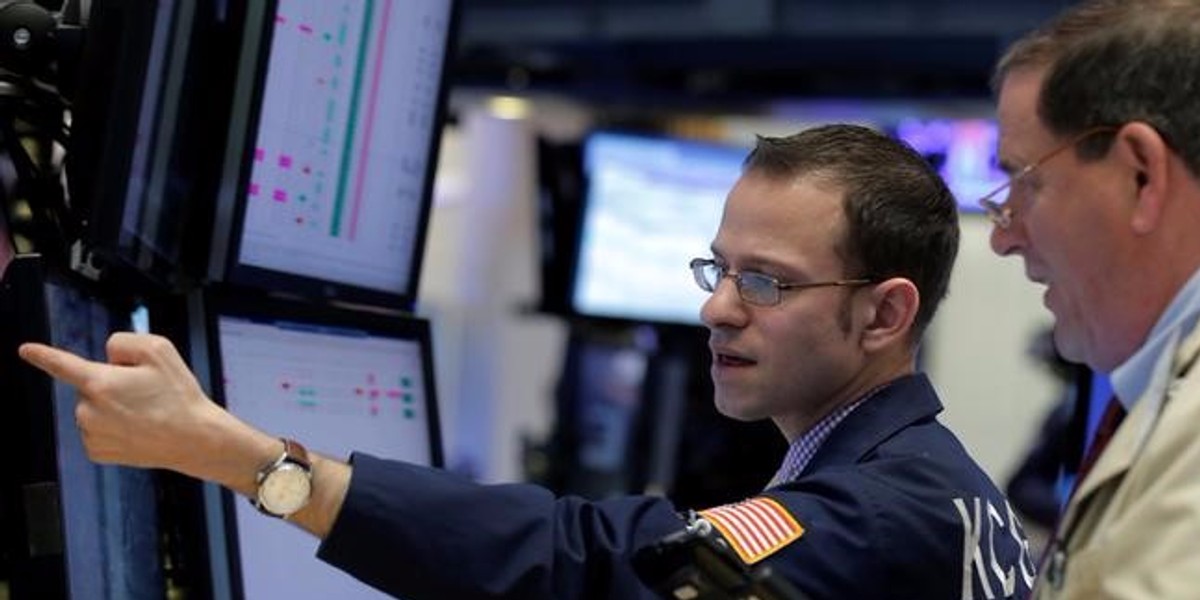 Traders work on the floor of the NYSE