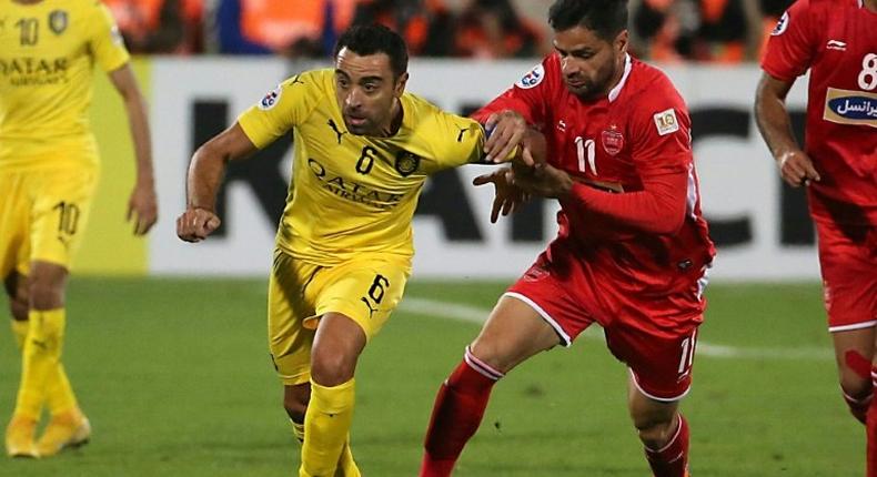 Spain great Xavi Hernandez (L), touted as a potential future manager of Qatar, believes the 2022 World Cup hosts can make progress on the international scene.