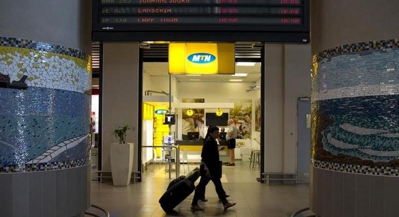 Travellers walk past an MTN telecom shop at King Shaka International Airport in Durban, South Africa, November 16, 2015. REUTERS/Rogan Ward
