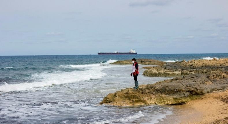 A Libyan Red Crescent volunteer looks for bodies in February 2017