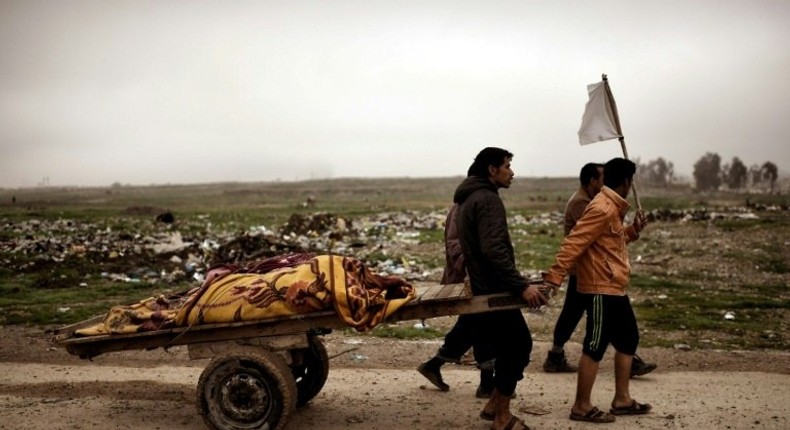 Relatives transport the bodies of west Mosul residents allegedly killed in an airstrike targeting Islamic State group jihadists on March 17, 2017