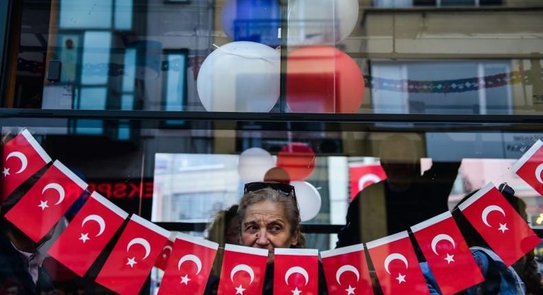 A woman looks from a window during a protest against the result of the nationwide referendum that will enhance the powers of President Erdogan powers in Istanbul on April 23, 2017