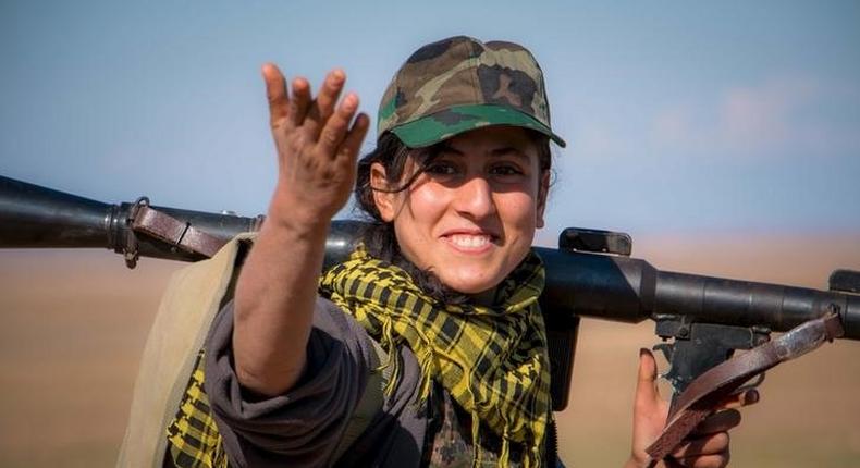 A Kurdish YPG fighter with her weapon near the al-Hawl area, the site of fighting between ISIS militants and Syrian Democratic Forces.