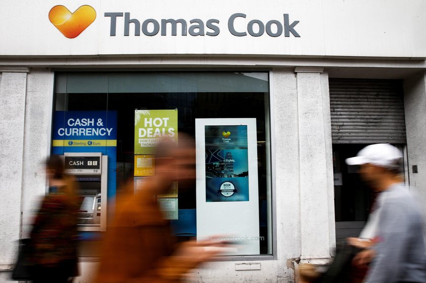 A television crew film outside of a closed Thomas Cook store in London