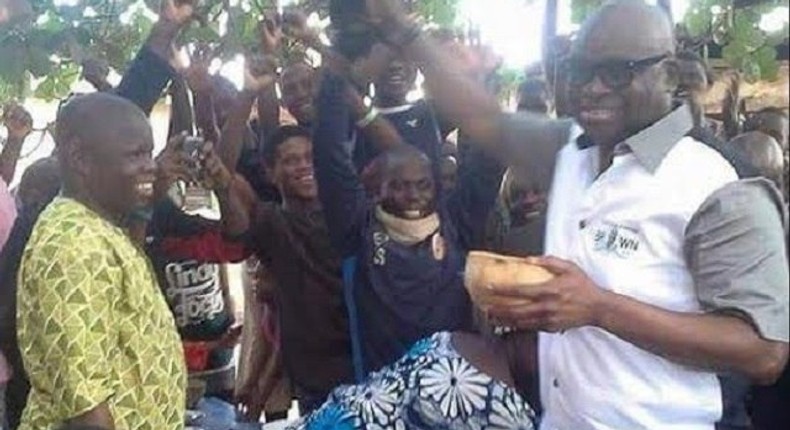 Ayo Fayose sampling his palmwine