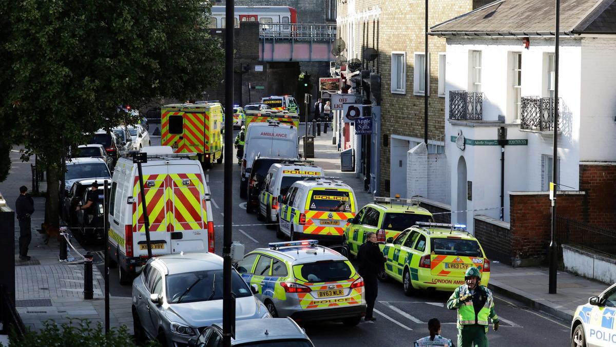 Police vehicles line the street near Parsons Green tube station in London