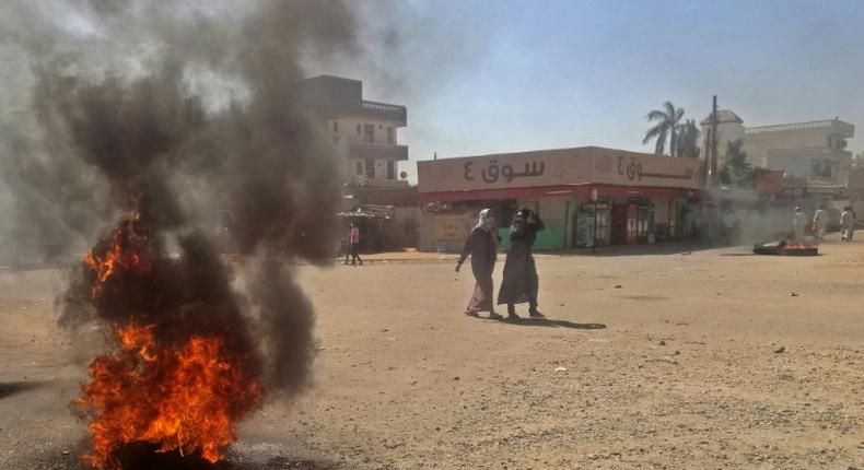 Sudanese protestors burn tyres during an anti-government demonstration on January 18, 2019 in Khartoum