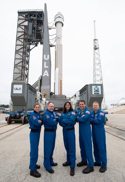 Nicole Mann (z lewej) i inni astronauci, którzy mają polecieć statkiem kosmicznym Boeing Starliner, pozują przed makietą pojazdu.