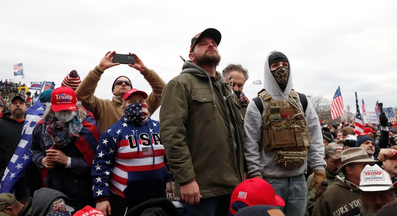 Pro-Trump protesters look on during clashes with Capitol police at a rally to contest the certification of the 2020 U.S. presidential election results by the U.S. Congress, at the U.S. Capitol Building in Washington, U.S, January 6, 2021.
