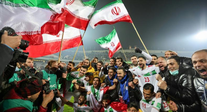 Iran's players celebrate with fans after qualifying for the 2022 Qatar World Cup finals in Qatar. Creator: Atta KENARE