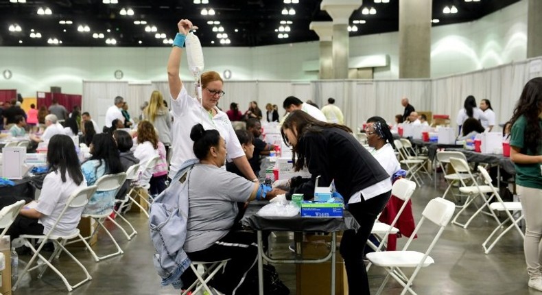 People visit a mobile free health clinic in Los Angeles - Life expectancy in the United States has dropped for the first time since the peak of the HIV/AIDS crisis more than 20 years ago