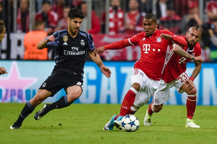 Bayern Munich's Arturo Vidal looks dejected after being sent off as Real Madrid's Sergio Ramos looks