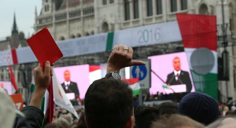 Anti-government demonstrators protest during the speech of Hungarian Prime Minister Viktor Orban in front of the Parliament in Budapest on October 23, 2016