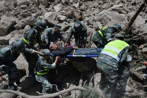 Chinese paramilitary police carry a survivor after an earthquake in Jiuzhaigou county