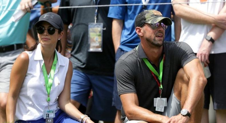 Swimmer Michael Phelps and his wife Nicole Johnson look on during the first round of the 2017 PGA Championship at Quail Hollow Club on August 10, 2017 in Charlotte, North Carolina