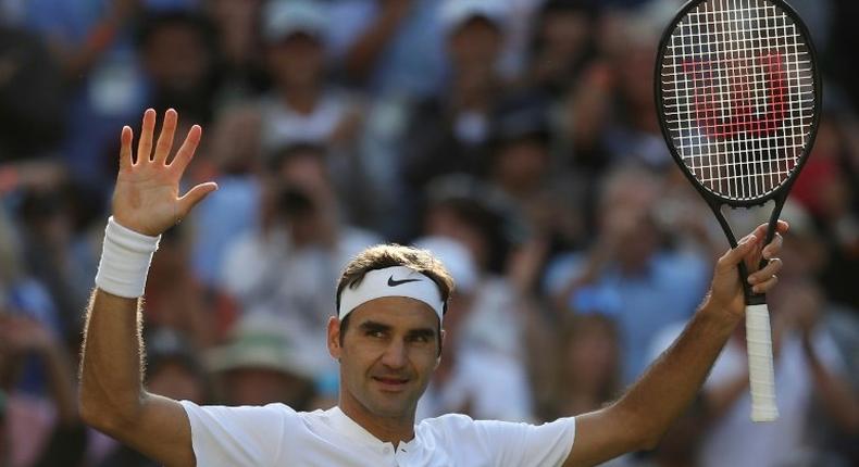 Switzerland's Roger Federer celebrates beating Canada's Milos Raonic during their men's singles quarter-final match on the ninth day of the 2017 Wimbledon Championships July 12, 2017