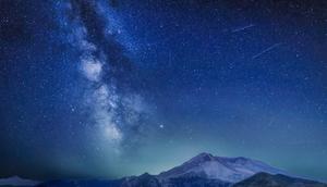 The Delta Aquariids meteor shower and Milky Way over Mount St. Helens, at Windy Ridge in Washington State with Mt. Hood, Oregon visible in the lower left corner. In 2023, it's occurring at the same time as the Alpha Capricornids shower.Diana Robinson Photography/Getty Images
