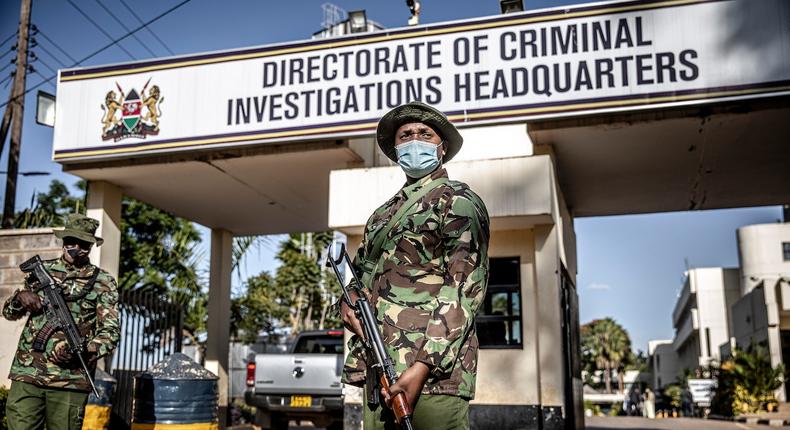 Police officers monitor the entrance to the DCI headquarters.  (Image- The Washington Post)