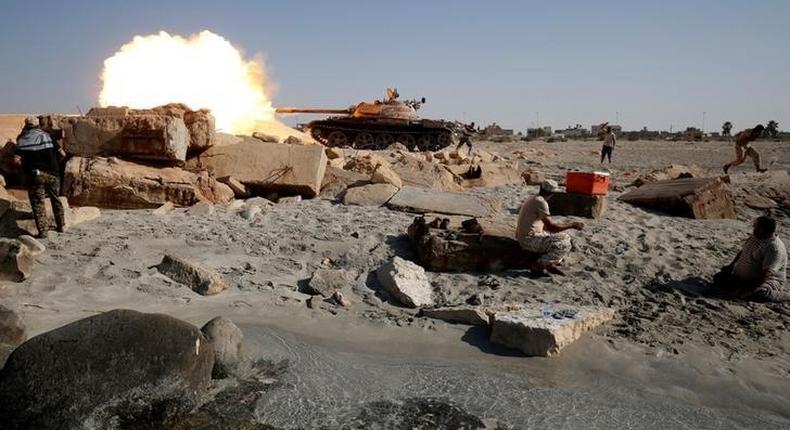 A fighter of Libyan forces allied with the U.N.-backed government fires a shell with Soviet made T-55 tank at Islamic State fighters from a beach in Sirte, Libya, August 3, 2016. 
