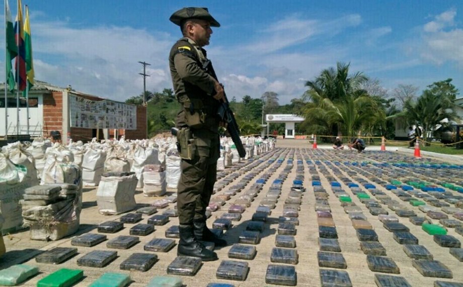 A Colombian police officer guards 8 tons of seized cocaine in Turbo, Antioquia department, in northwestern Colombia, on May 15, 2016.