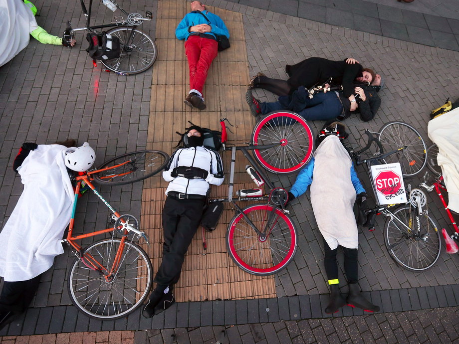 Cyclists stage a "die-in" protest in London to raise awareness of road safety.