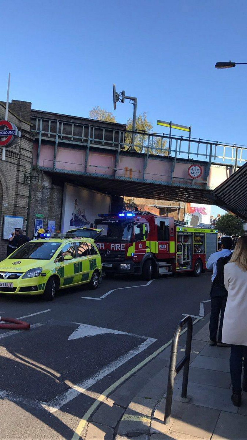 Emergency services tend to an injured woman following a blast on an underground train at Parsons Gre