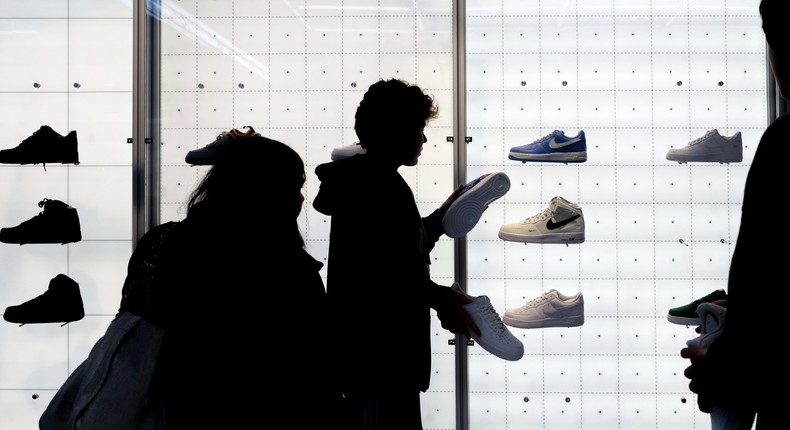 People shop for shoes in a Nike store on , Nov. 25, 2022, in New York.AP Photo/Julia Nikhinson