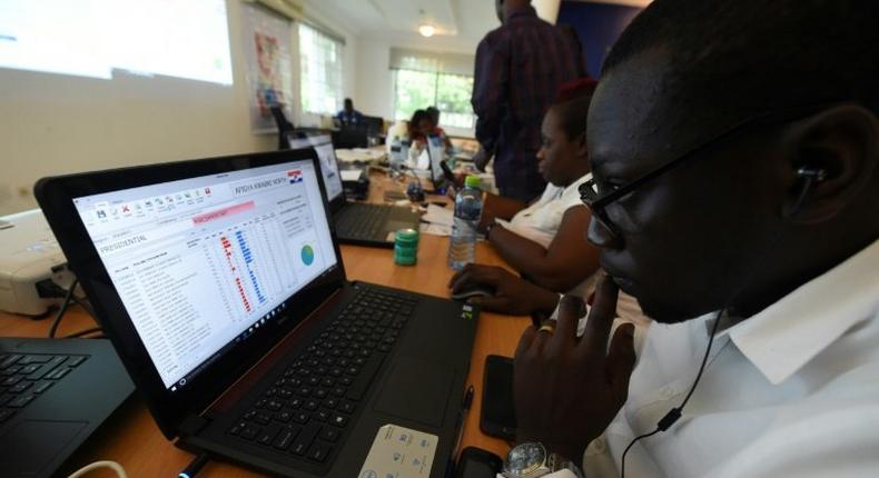 Officials of the opposition New Patriotic Party record results posted by party agents at its collection centre in Accra, on December 8, 2016