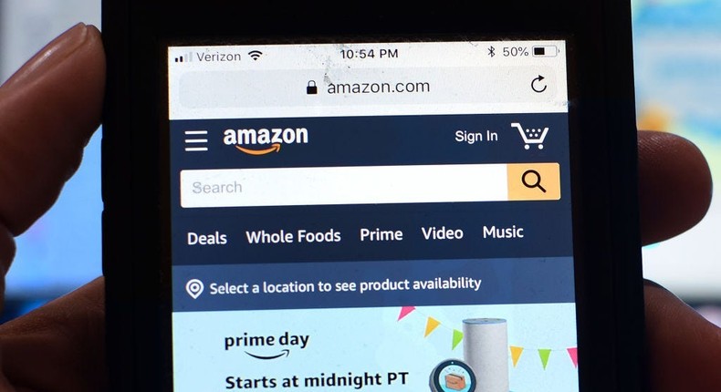 Shopper holding a phone on Amazon Prime Day.