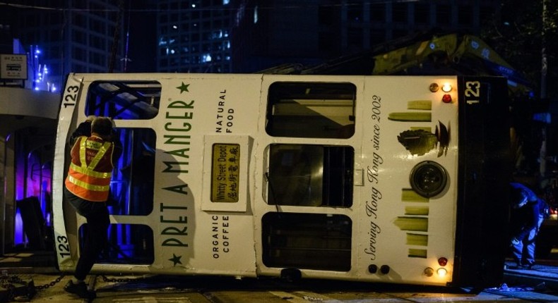 Five women and nine men were injured when a Hong Kong tram flipped over in the city's financial district in the early hours of Thursday