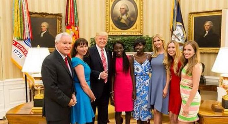 President Donald Trump with Joy Bishara and Lydia Pogu in the White House