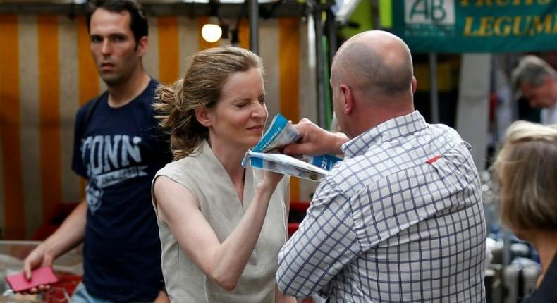 A passerby, who has been identified as Vincent Debraize, mayor of Champignolles, takes leaflets from the hand of Les Republicains (LR) party candidate Nathalie Kosciusko-Morizet during an altercation while campaigning in Paris on June 15, 2017